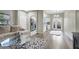Spacious living room connected to the kitchen, featuring wood floors and contemporary decor at 10553 Pine Glen Ave # 101, Las Vegas, NV 89144