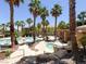 Community pool area with palm trees, lounge chairs, and a relaxing spa at 10553 Pine Glen Ave # 101, Las Vegas, NV 89144