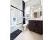 A bathroom features a shower and a dark wood vanity with a white sink and countertop at 146 Cabo Cruces Dr, Henderson, NV 89011