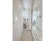 Modern glass shower featuring stone tiled walls and flooring at 146 Cabo Cruces Dr, Henderson, NV 89011