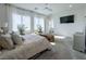 Bright bedroom featuring large windows, decorative plants and plush furniture at 146 Cabo Cruces Dr, Henderson, NV 89011