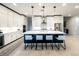 This kitchen features a large island with seating, stainless steel appliances, and modern pendant lighting at 146 Cabo Cruces Dr, Henderson, NV 89011