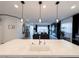 A modern kitchen features a large island, stainless steel sink, and an open view into the living area at 146 Cabo Cruces Dr, Henderson, NV 89011