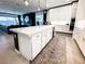 Contemporary kitchen featuring a spacious island, stylish cabinetry, and a seamless connection to the living area at 146 Cabo Cruces Dr, Henderson, NV 89011
