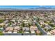 Panoramic aerial showcasing a vibrant neighborhood with manicured lawns, community spaces, and distant mountain scenery at 1509 Winslow St, Las Vegas, NV 89117