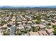 Expansive aerial view of a residential neighborhood with lush greenery, mature trees, and panoramic mountain views at 1509 Winslow St, Las Vegas, NV 89117