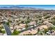 Expansive aerial view of a desert community with lush landscaping, pools, and mountain views at 1509 Winslow St, Las Vegas, NV 89117