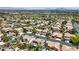 Expansive aerial view of a residential neighborhood with lush greenery, mature trees, and panoramic mountain views at 1509 Winslow St, Las Vegas, NV 89117