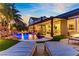 Inviting backyard pool with waterfall feature, lush landscaping, and comfortable lounge seating, perfect for relaxation at 1509 Winslow St, Las Vegas, NV 89117
