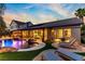 Inviting backyard pool with waterfall feature, lush landscaping, and comfortable lounge seating, perfect for relaxation at 1509 Winslow St, Las Vegas, NV 89117