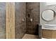 Modern bathroom features a tiled shower with a rain shower head, and a vessel sink atop a stylish vanity at 1509 Winslow St, Las Vegas, NV 89117