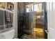Modern bathroom with tiled shower with pebble accents, overhead rain shower and glass door at 1509 Winslow St, Las Vegas, NV 89117