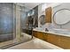 Beautiful bathroom featuring double sinks, stone countertops, modern cabinets, and a large, glass-enclosed shower at 1509 Winslow St, Las Vegas, NV 89117
