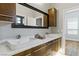 Bathroom with double sinks, marble countertop and sleek wood drawers and cabinet at 1509 Winslow St, Las Vegas, NV 89117