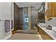 Beautiful bathroom featuring double sinks, stone countertops, modern cabinets, and a large, glass-enclosed shower at 1509 Winslow St, Las Vegas, NV 89117