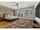 A spacious bedroom features a modern wooden bed, large windows, and a stylish area rug at 1509 Winslow St, Las Vegas, NV 89117