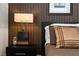 Stylish bedroom showcasing an accent wall, designer lamp, and comfortable bedding at 1509 Winslow St, Las Vegas, NV 89117