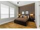 Bedroom with wood floors, decorative wood-look accent wall, and large windows for natural light at 1509 Winslow St, Las Vegas, NV 89117