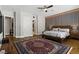 Spacious bedroom with wood accents, a large bed, and an eye-catching decorative area rug at 1509 Winslow St, Las Vegas, NV 89117