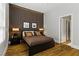 Bedroom with wood floors, decorative wood-look accent wall, and large windows for natural light at 1509 Winslow St, Las Vegas, NV 89117