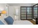Bright bedroom featuring a sliding door closet, neutral tones, and hardwood floors at 1509 Winslow St, Las Vegas, NV 89117