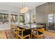 Spacious dining room with a large table, modern lighting, and views of the outdoors at 1509 Winslow St, Las Vegas, NV 89117
