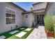 Inviting front entrance with artificial grass, modern landscaping, and a stylish, contemporary door at 1509 Winslow St, Las Vegas, NV 89117