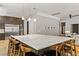 A kitchen with dark wood cabinets, stainless steel appliances, and a large center island with a white countertop and seating at 1509 Winslow St, Las Vegas, NV 89117
