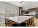 An expansive kitchen with a large island featuring barstool seating and bright windows with modern blinds at 1509 Winslow St, Las Vegas, NV 89117