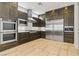 Kitchen boasts stainless steel appliances, dark wood cabinets, and tile flooring at 1509 Winslow St, Las Vegas, NV 89117