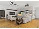 Open-concept living room with a modern design, hardwood floors, and large windows at 1509 Winslow St, Las Vegas, NV 89117