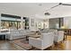 Open-concept living room with modern furniture, sleek ceiling fan and hardwood floors at 1509 Winslow St, Las Vegas, NV 89117