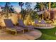 Secluded backyard lounge area with modern chaise lounges and manicured landscaping, ideal for relaxation at 1509 Winslow St, Las Vegas, NV 89117