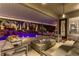 Luxurious covered patio featuring a pool view, seating area and lush landscaping at 1509 Winslow St, Las Vegas, NV 89117
