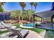 Resort-style pool area with lounge chairs, built-in BBQ, and a rock waterfall feature at 1509 Winslow St, Las Vegas, NV 89117