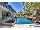 The backyard features a sparkling pool with rock waterfall and an integrated spa at 1509 Winslow St, Las Vegas, NV 89117