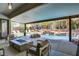 Covered patio and outdoor space with a waterfall feature and a pool with lush landscaping at 1509 Winslow St, Las Vegas, NV 89117
