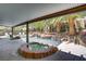 Inviting pool features a rock waterfall, tropical landscaping, and covered seating area at 1509 Winslow St, Las Vegas, NV 89117