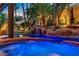 Stunning pool with rock waterfall feature surrounded by lush tropical landscaping at 1509 Winslow St, Las Vegas, NV 89117