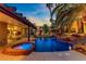 Backyard oasis featuring a custom pool with a waterfall, spa, and covered patio at 1509 Winslow St, Las Vegas, NV 89117