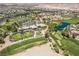 Aerial view of lush green golf course featuring mature trees and a clubhouse at 151 Duckhook Ave, Las Vegas, NV 89148