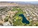 Breathtaking aerial view of a golf course community featuring lush greenery and a serene lake at 151 Duckhook Ave, Las Vegas, NV 89148