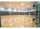 Indoor basketball court with polished wood flooring and a clear partition for viewing at 151 Duckhook Ave, Las Vegas, NV 89148