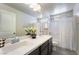 Bathroom featuring double sinks, large mirror, decorative flower and white shower curtain, combining functionality with style at 151 Duckhook Ave, Las Vegas, NV 89148