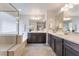 Elegant primary bathroom with double sinks, a soaking tub, and a glass-enclosed shower at 151 Duckhook Ave, Las Vegas, NV 89148