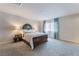 Serene bedroom with soft carpet, sheer curtains, and decorative lamps, creating a cozy retreat at 151 Duckhook Ave, Las Vegas, NV 89148