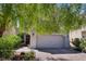 Inviting single-Gathering home with a well-maintained yard, mature trees, and a two-car garage at 151 Duckhook Ave, Las Vegas, NV 89148