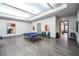 Bright game room equipped with a ping pong table, artwork, and comfortable seating for recreation at 151 Duckhook Ave, Las Vegas, NV 89148