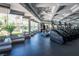 Modern gym with a row of treadmills facing large windows and lush greenery, offering a scenic workout at 151 Duckhook Ave, Las Vegas, NV 89148