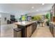 Stylish kitchen with granite countertops, a large island, and an open view to the dining and living areas at 151 Duckhook Ave, Las Vegas, NV 89148
